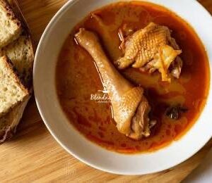 Steaming hot chicken soup bowl