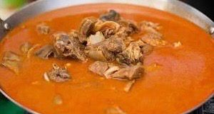 Steaming hot goat soup bowl
